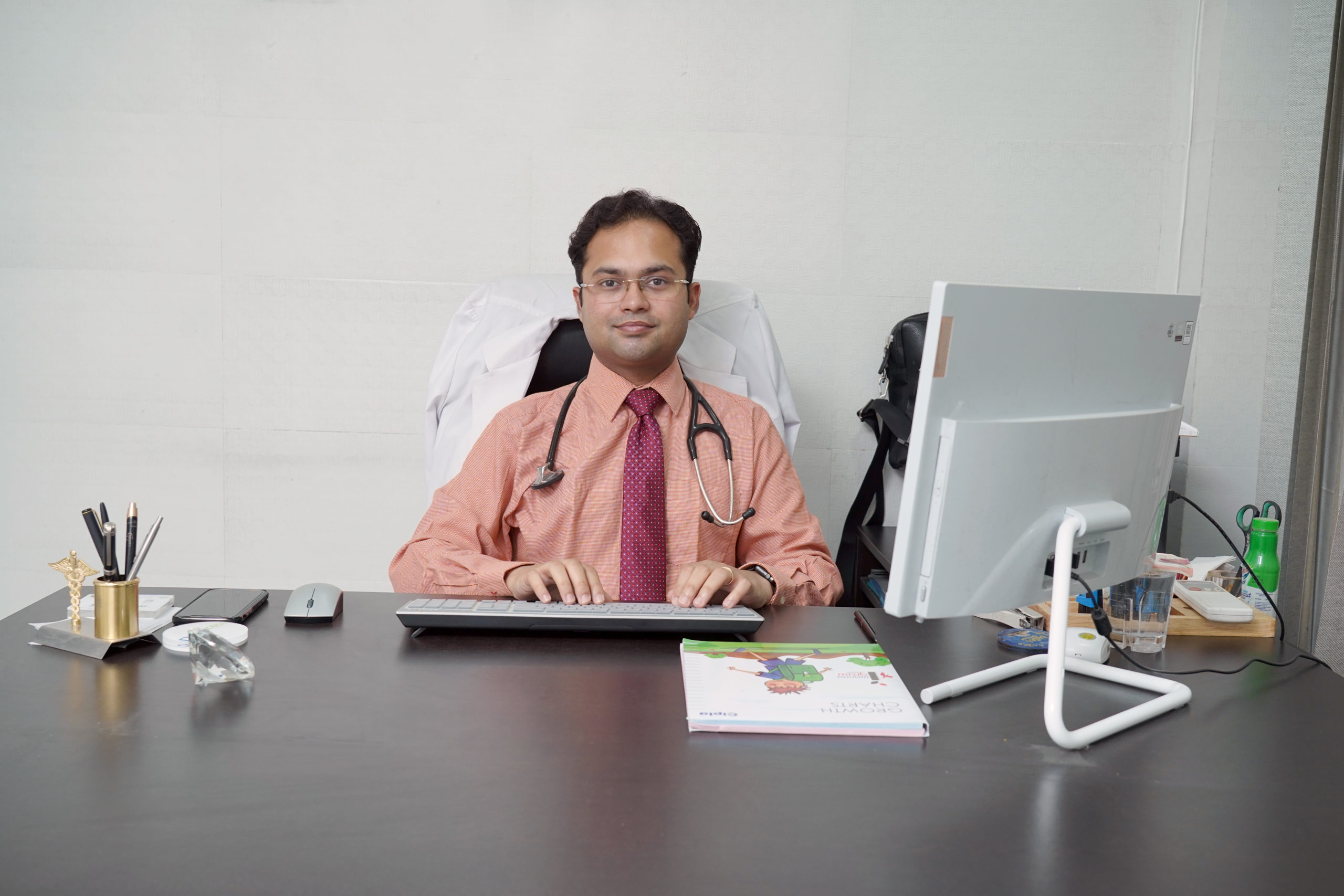 Best endocrinologist and diabetologist in Patiala sitting in their office at Rapid Lab, ready to provide expert medical care.